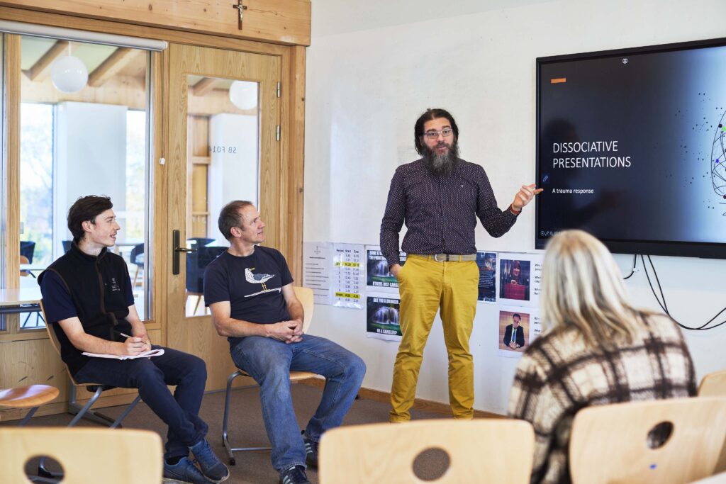 Giovanni Felice Pace teaching a psychotherapy training session at Worth School, presenting clinical material to students during an in-person weekend at The Metis Institute.