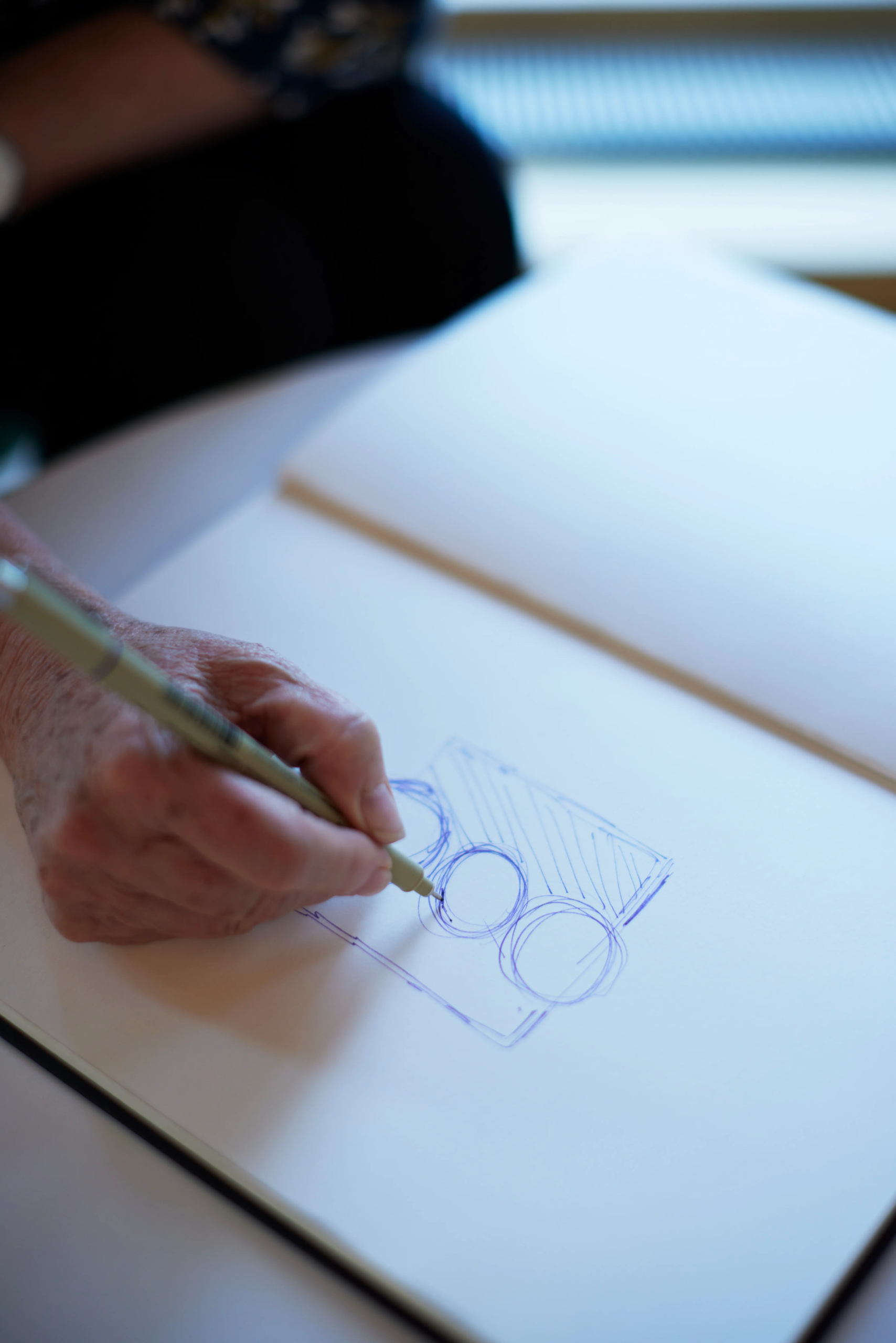 Hand sketching a simple diagram in a notebook during TA101 Transactional Analysis training at The Metis Institute.