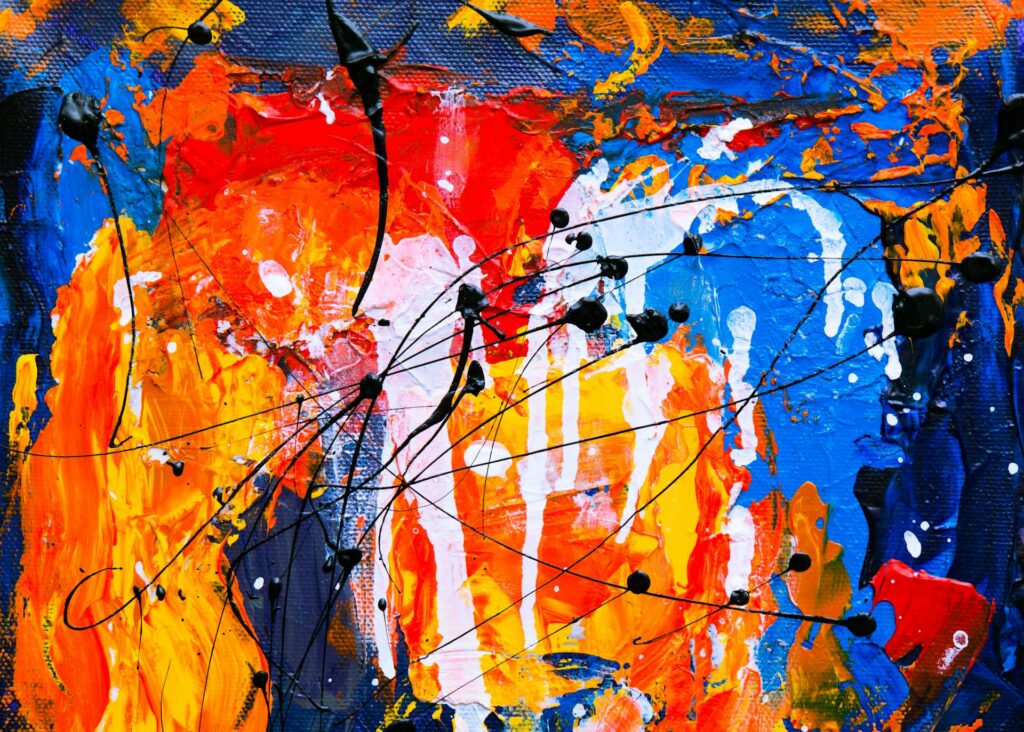 Bold abstract painting with layered orange, blue, red, and yellow paint, with black splatters and drips across the surface.